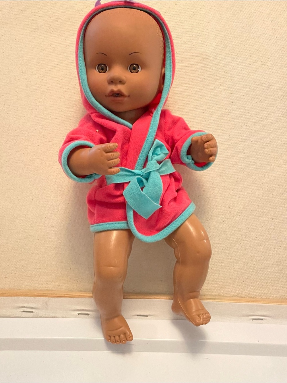 2 baby dolls one regular size baby in bath robe one small baby in dress